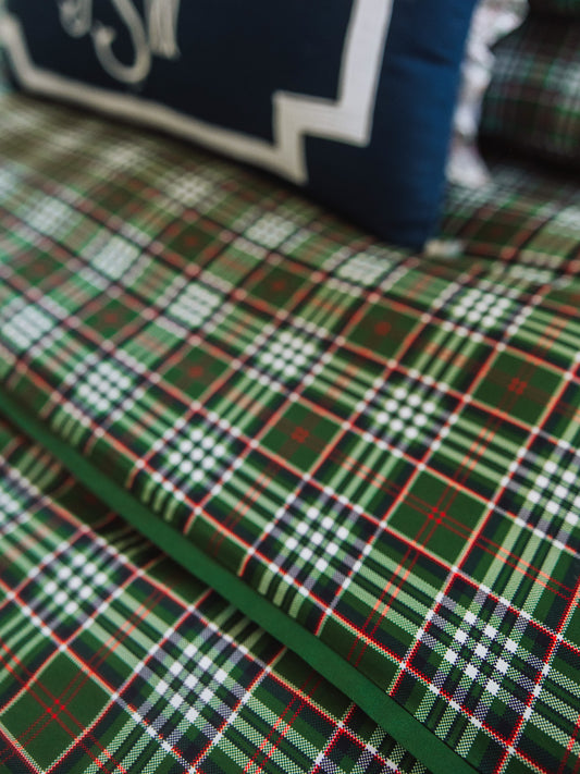 Up close picture of green plaid bedding print.