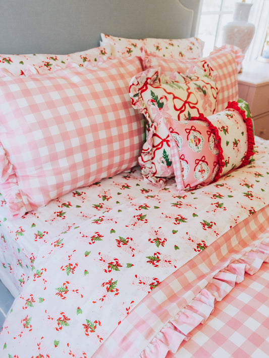 holiday themed bedding with pink gingham print and other matching holiday prints.
