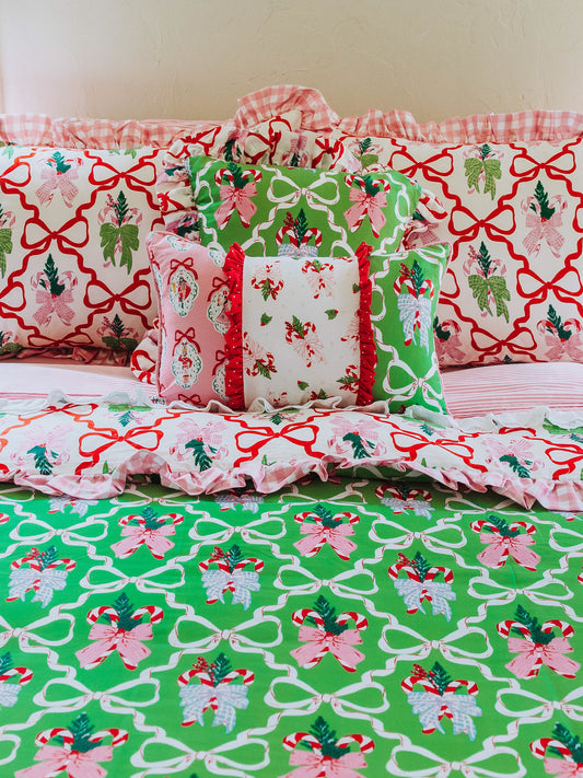 Holiday themed bedding shown with different sized pillows in matching prints.