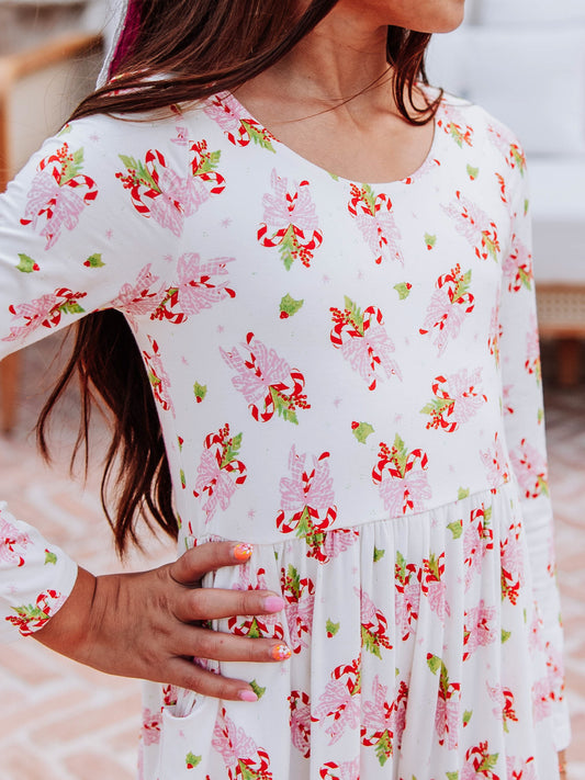Up close print of sweet candy cane print on leggy romper.