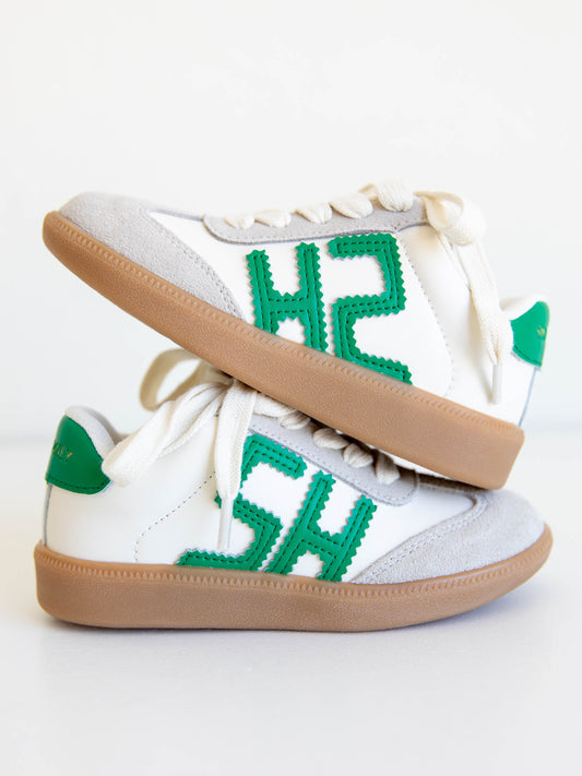 Fresh, fun, and full of SweetHoney style — our Signature Sneakers in green and white are the perfect mix of comfort and charm! Featuring our bold “SH” SweetHoney logo, soft suede accents, and durable gum soles, these boutique kids’ sneakers are designed for everyday adventures. Whether paired with twirl dresses or playtime outfits, they’re the ultimate blend of fashion and function for little trendsetters on the go.