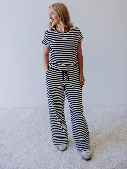 Model is wearing a two piece, navy and ivory pant set. Top has a stitched Sweethoney tag centered on chest.