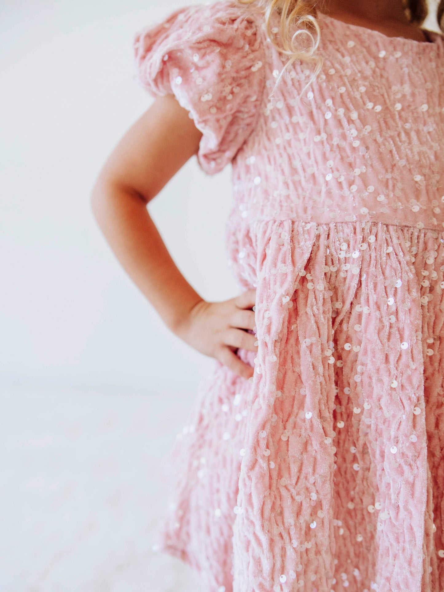 Make every moment shine in our Girls’ Sequin Sparkle Dress, designed for holiday parties, special occasions, and picture-perfect moments. Crafted from 100% polyester, this dress features a soft velvet-like texture that’s gentle on the skin and a smooth interior lining for all-day comfort. The fabric is covered in shimmering transparent sequins that catch the light beautifully, creating a dazzling effect with every twirl.