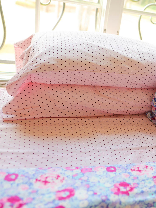 Brighten up any bedroom with our Purple Polka Dot Sheet Set, designed for sweetness, softness, and everyday comfort. Featuring a charming blush-pink base sprinkled with tiny, delicate polka dots, this set adds a playful yet polished touch to your child’s bedding. Crafted from smooth, breathable fabric, these sheets keep little sleepers cozy through every season. The lightweight weave offers a soft-to-the-touch feel, while the durable construction ensures long-lasting quality wash after wash.