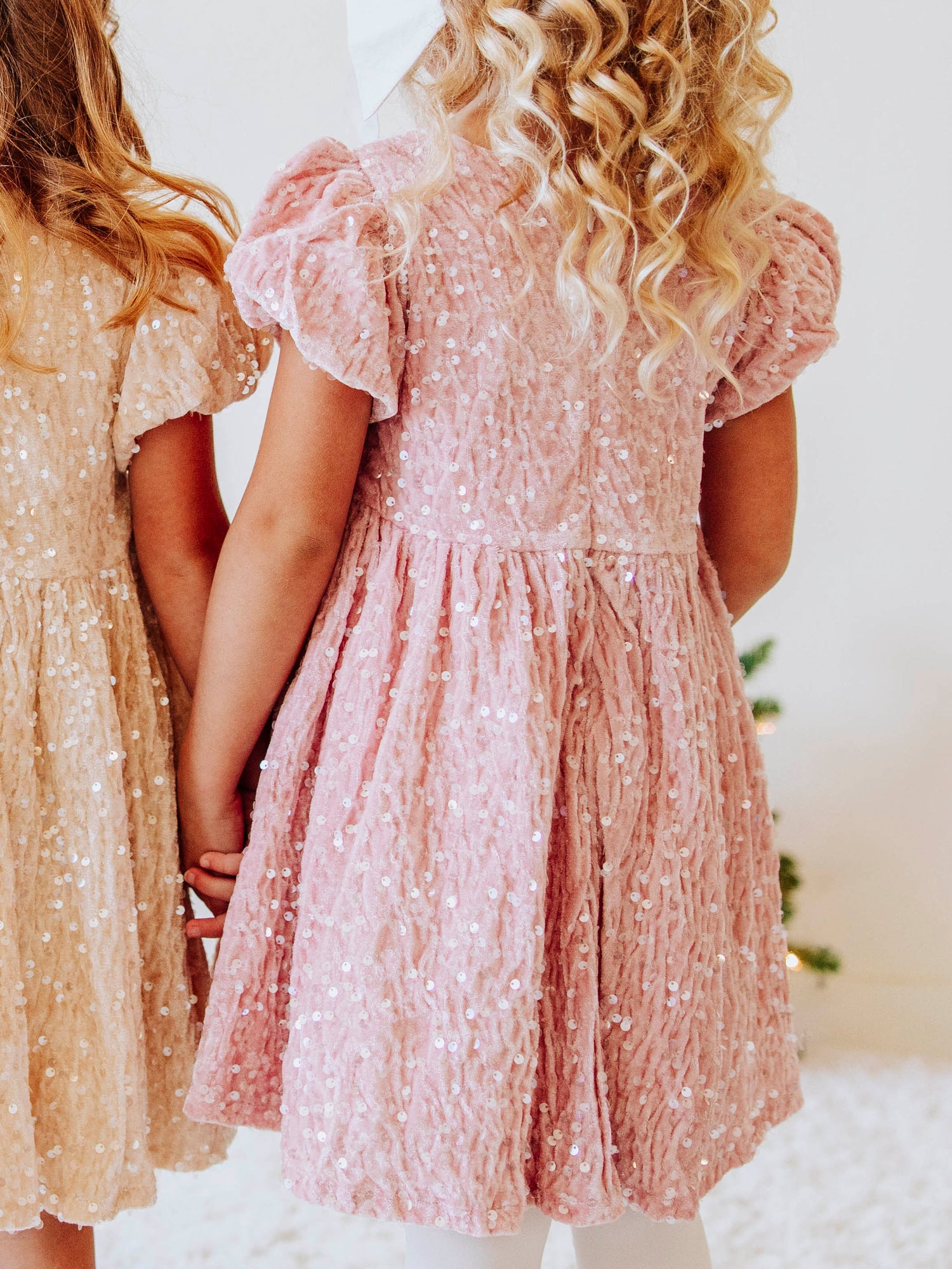 Make every moment shine in our Girls’ Sequin Sparkle Dress, designed for holiday parties, special occasions, and picture-perfect moments. Crafted from 100% polyester, this dress features a soft velvet-like texture that’s gentle on the skin and a smooth interior lining for all-day comfort. The fabric is covered in shimmering transparent sequins that catch the light beautifully, creating a dazzling effect with every twirl.