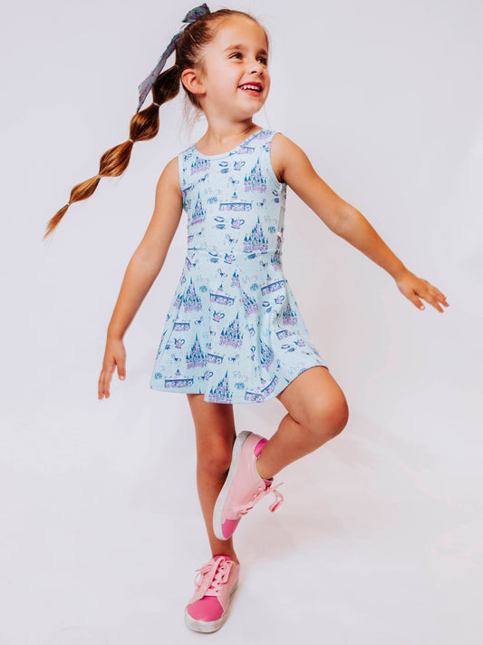 Serve up style and fun with our girls’ “Most Magical” tennis dress, designed for comfort, movement, and everyday play. This adorable sleeveless dress features a whimsical print inspired by magical castles, carousels, and fairy-tale adventures — perfect for little dreamers who love both sports and sparkle. The lightweight, stretchy performance fabric keeps her cool and comfortable from the court to the playground, while the flared skirt design allows for easy twirls and active fun.