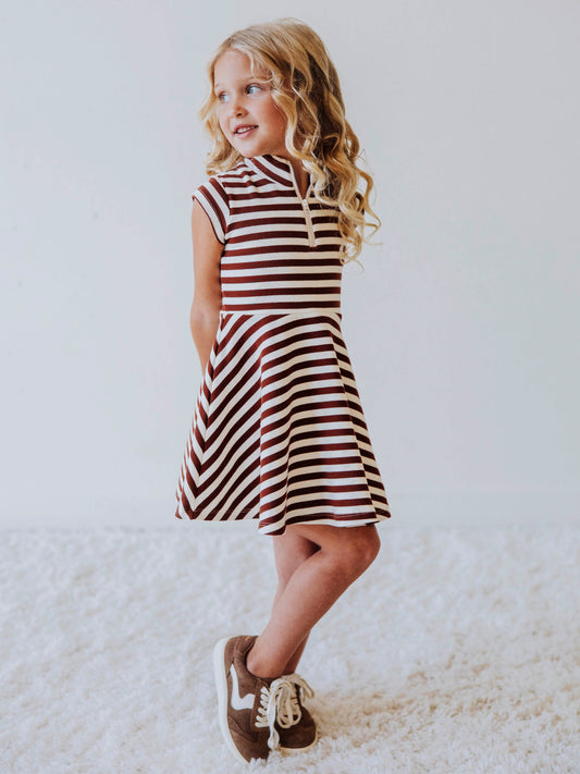 Model wearing a brown and ivory striped dress. Model is wearing brown shoes too.