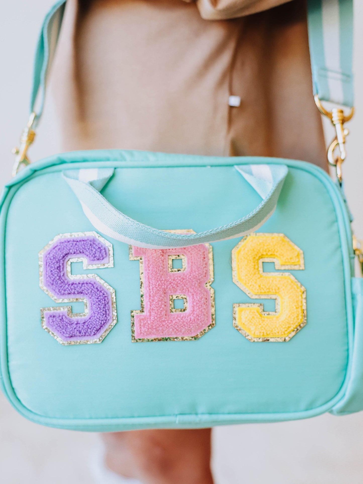 SBS spelled out in letter patches on lunch kit