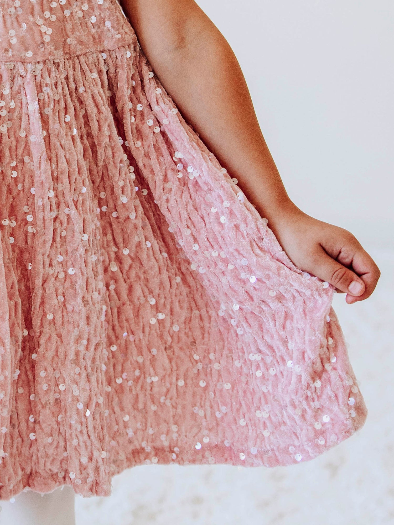 Make every moment shine in our Girls’ Sequin Sparkle Dress, designed for holiday parties, special occasions, and picture-perfect moments. Crafted from 100% polyester, this dress features a soft velvet-like texture that’s gentle on the skin and a smooth interior lining for all-day comfort. The fabric is covered in shimmering transparent sequins that catch the light beautifully, creating a dazzling effect with every twirl.