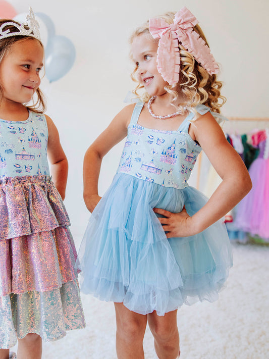 Bring a little fairytale sparkle to her wardrobe with our Most Magical Tulle Dress! Designed for twirls and make-believe moments, this enchanting girls’ dress features our whimsical Most Magical print on a soft, stretchy bodice paired with a full layered tulle skirt for the ultimate princess look. Perfect for birthdays, special occasions, or everyday play, it comfort and charm. Finished with delicate straps and a flowy silhouette, this dress makes every girl feel like she’s stepped into a fairytale!