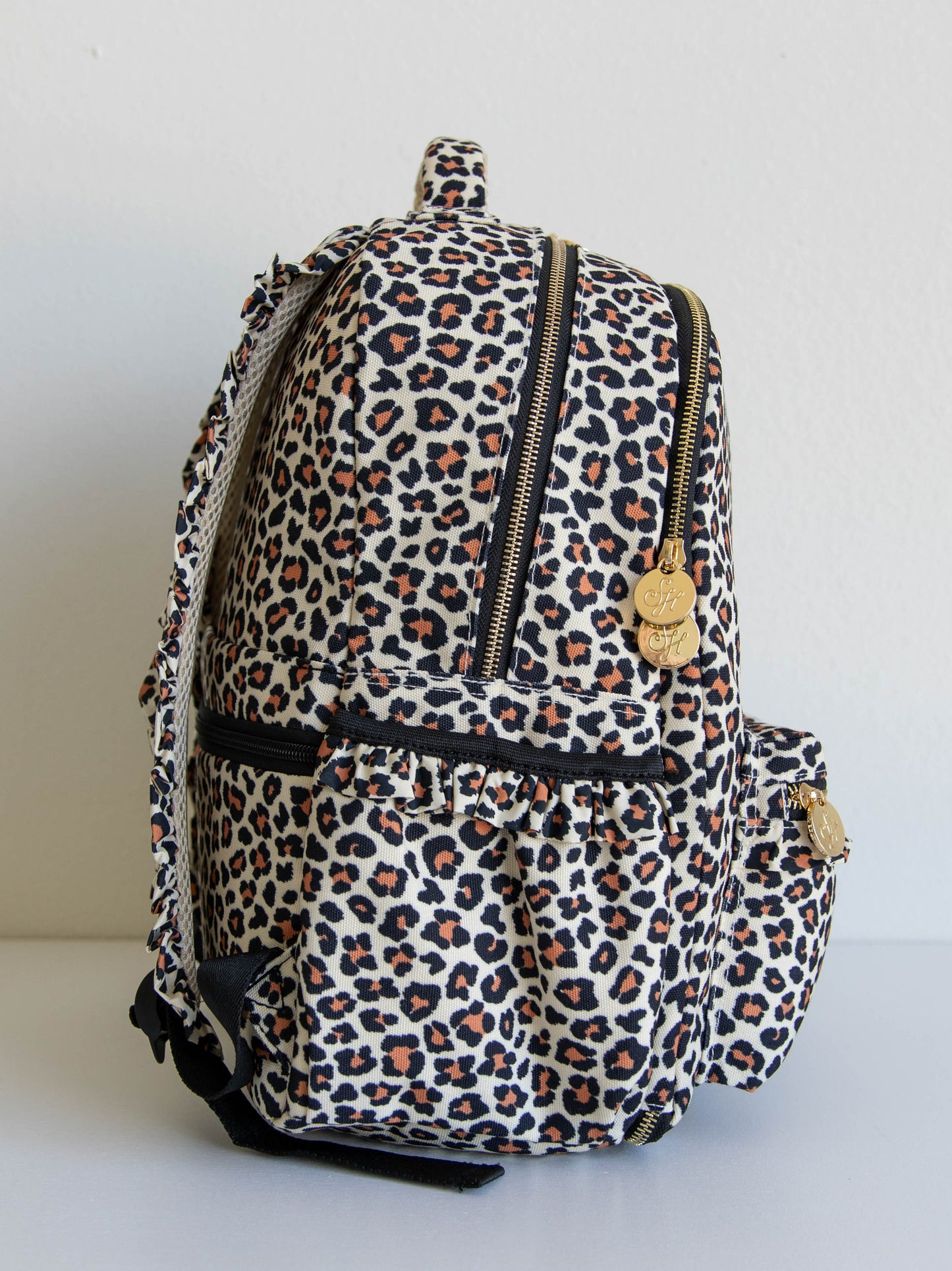 Leopard backpack with ruffled back straps and gold SH engraved zipper pulls