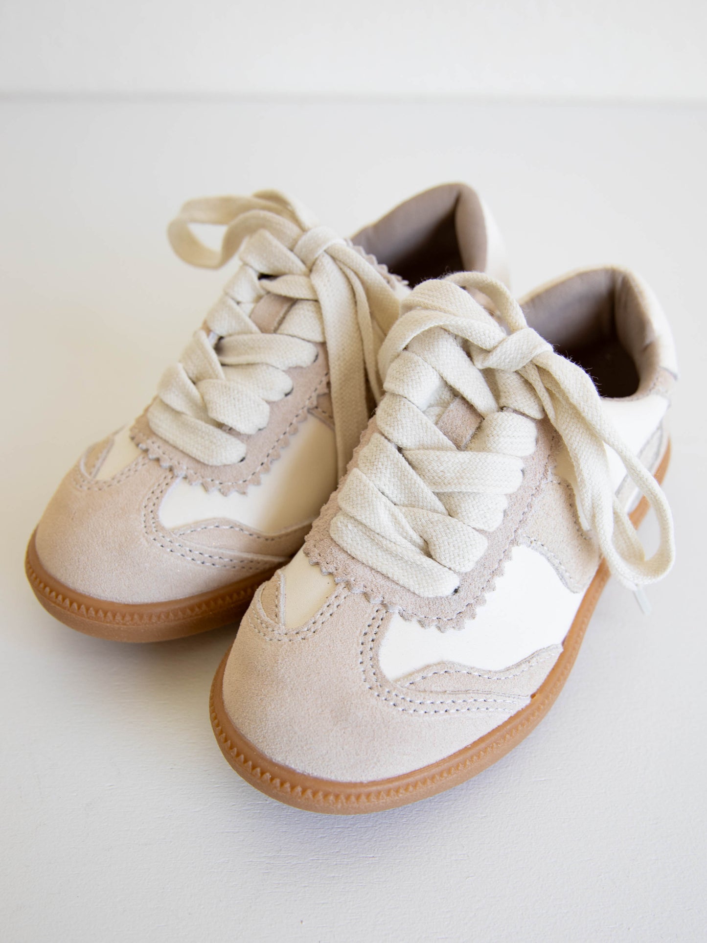 Tennis shoe with hints of shimmer. Rubber sole and shoe lace closure
