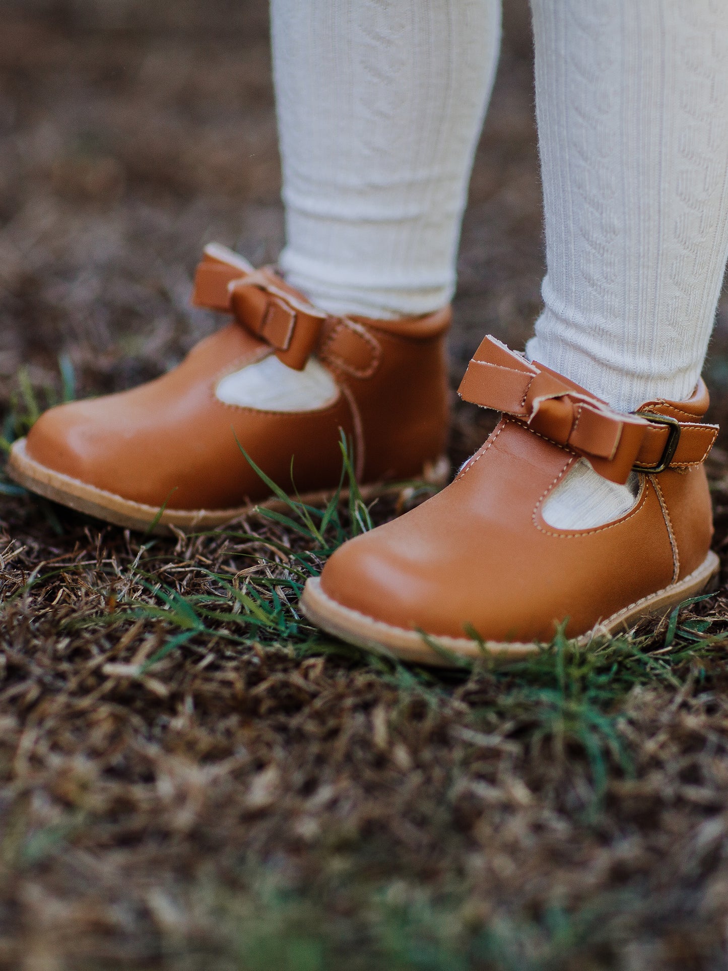 Brown Leather/Manmade material ankle boots with decorative buckle over the velcro closure. Has cute little openings right below the strap for ventilation and to show off your cute socks.