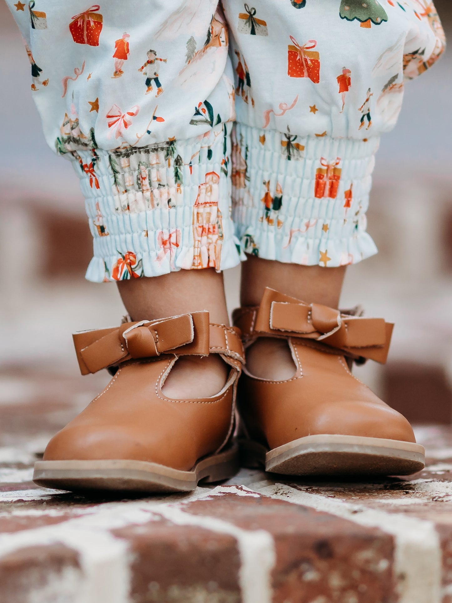 Brown Leather/Manmade material ankle boots with decorative buckle over the velcro closure. Has cute little openings right below the strap for ventilation and to show off your cute socks.