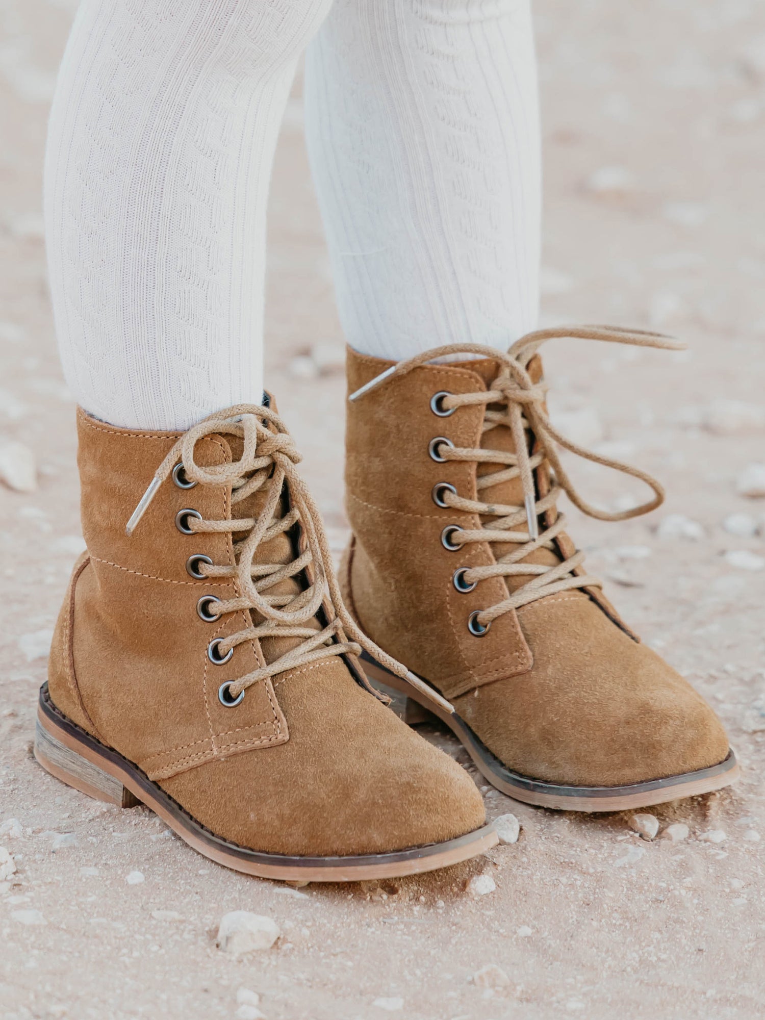 Sharp Boots. This camel suede lace-up boot has a rubber sole, metal eyelets, and nice thick laces. With a design that supports the ankle, these boots are perfect for some outdoor fun.