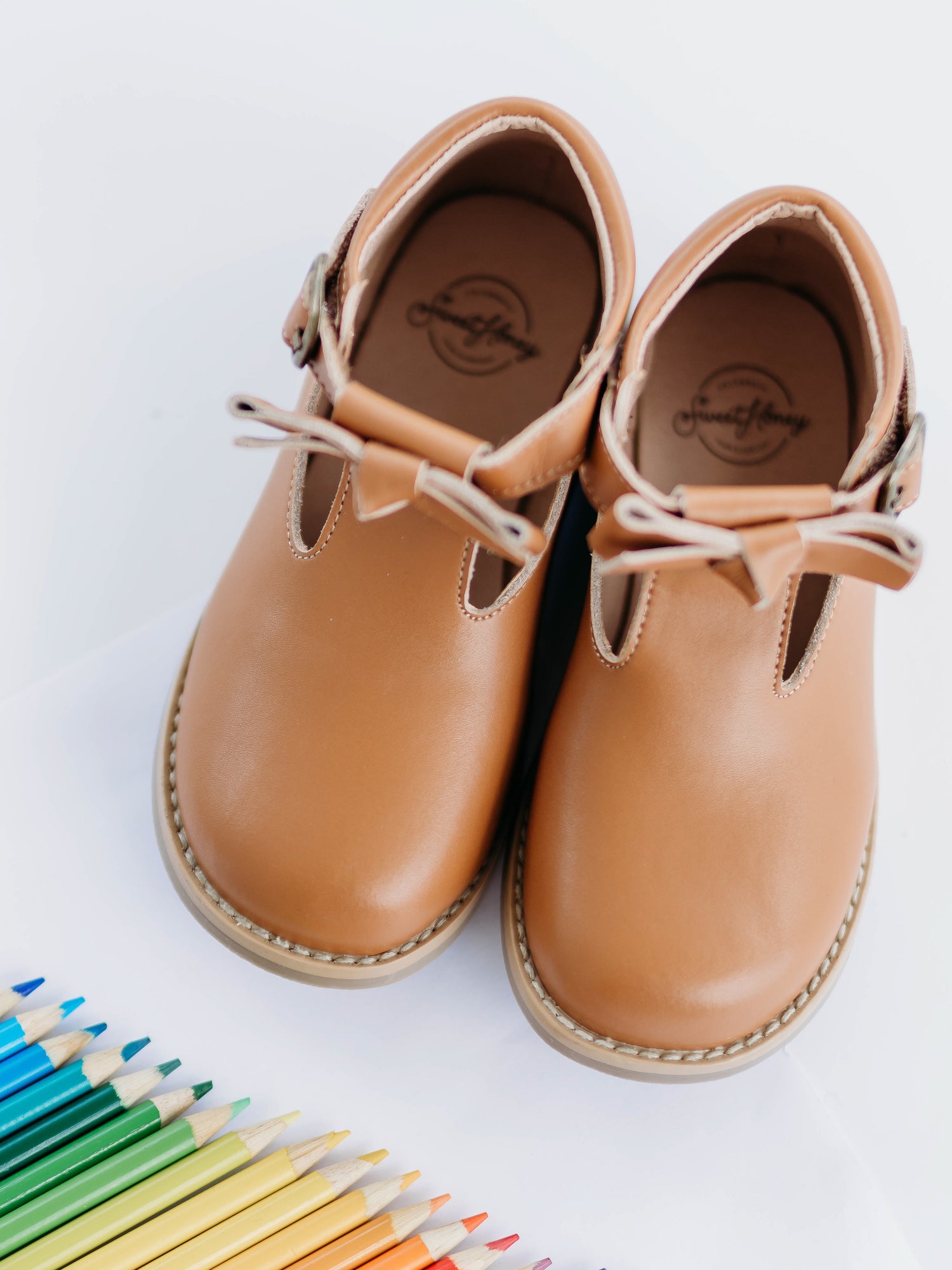 Brown Leather/Manmade material ankle boots with decorative buckle over the velcro closure. Has cute little openings right below the strap for ventilation and to show off your cute socks.