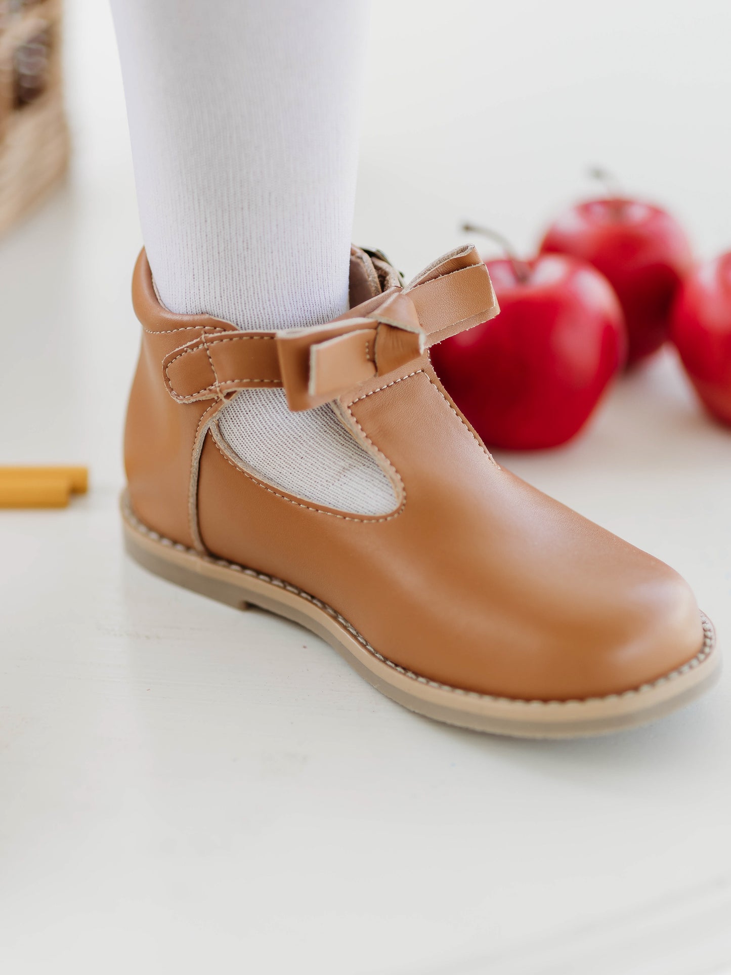 Brown Leather/Manmade material ankle boots with decorative buckle over the velcro closure. Has cute little openings right below the strap for ventilation and to show off your cute socks.