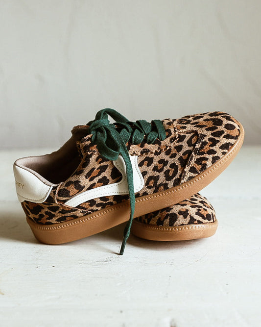 Pair of leooard printed tennis shoes with green laces and rubber sole. 