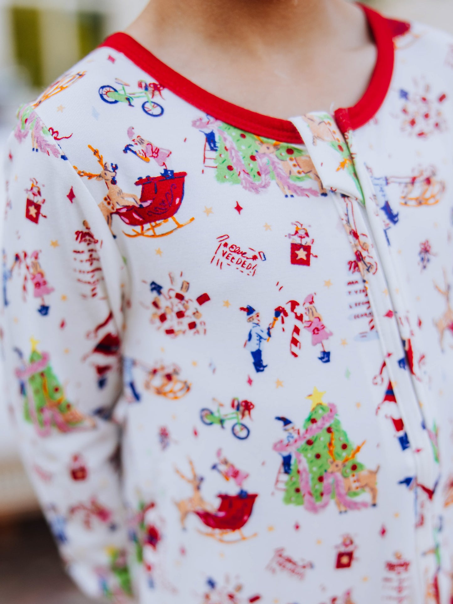 Close up of boy wearing a north pole printed layette. 
