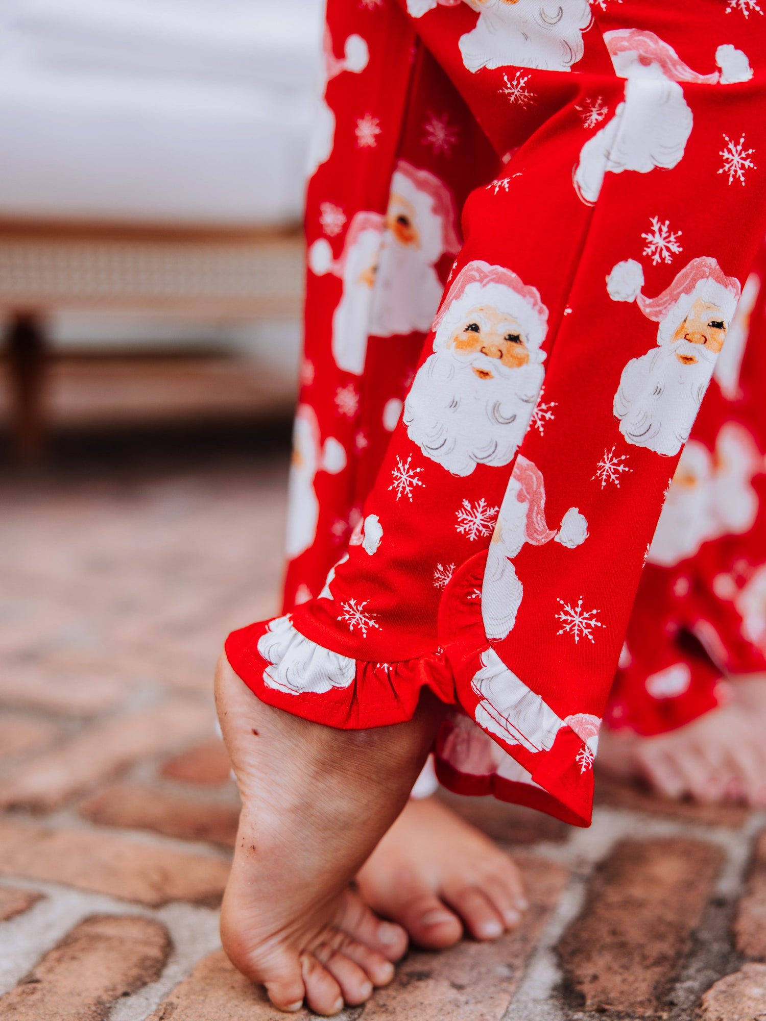 Close up of ruffles on the pant leg of red santa set. 