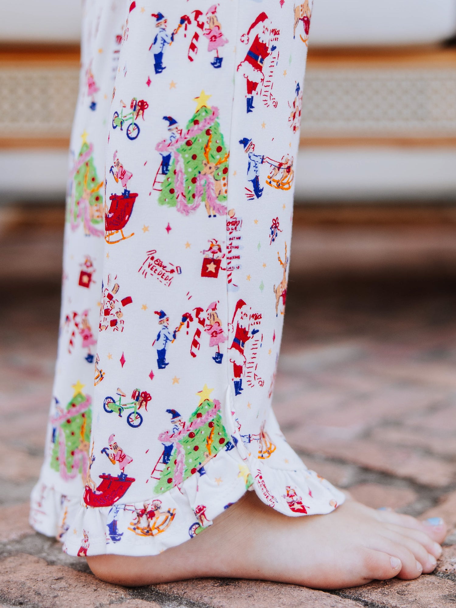 Up close shot of the ruffled detail on ruffled pants. Pattern is north pole. 