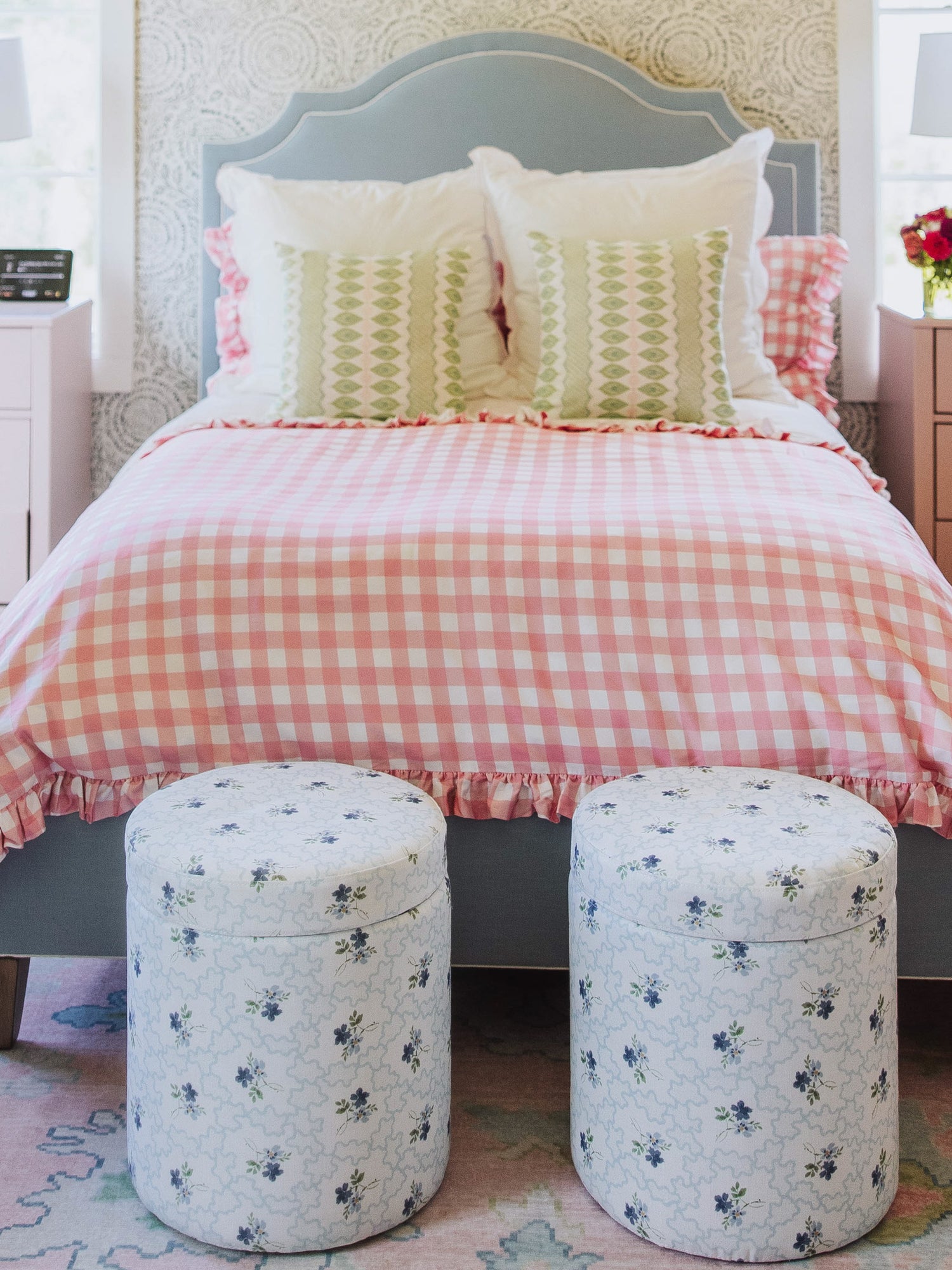 Pink check duvet with different decorative pillows. 