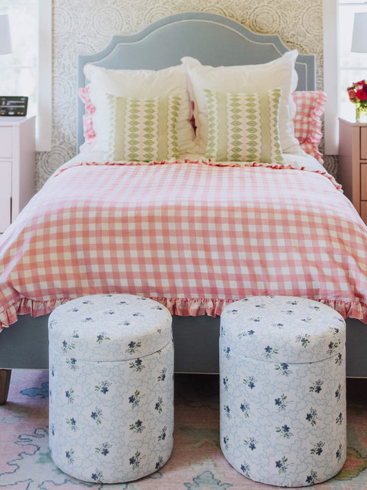 Pink check duvet with different decorative pillows. 
