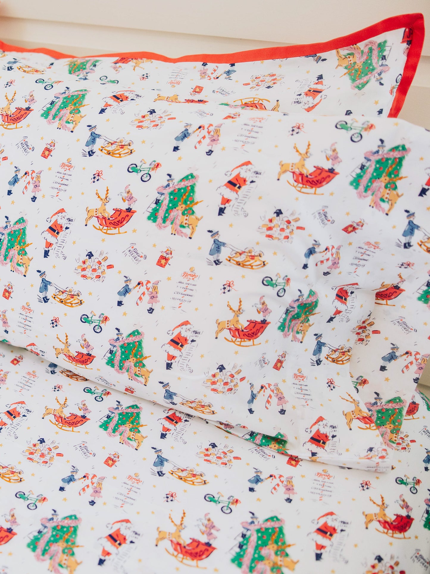 Holiday themed sheets and pillow cases on made up bed. 