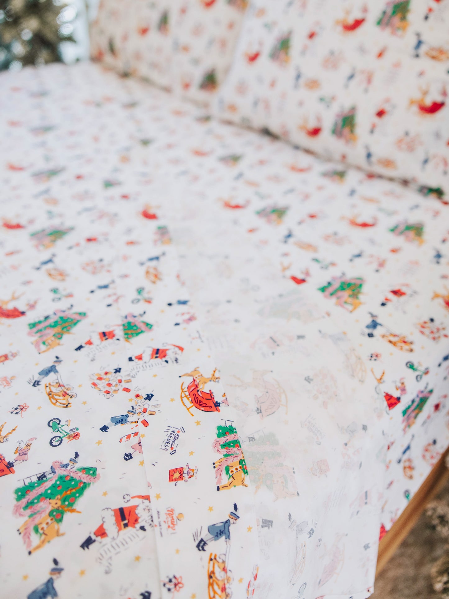 Holiday themed sheets on made up bed. 