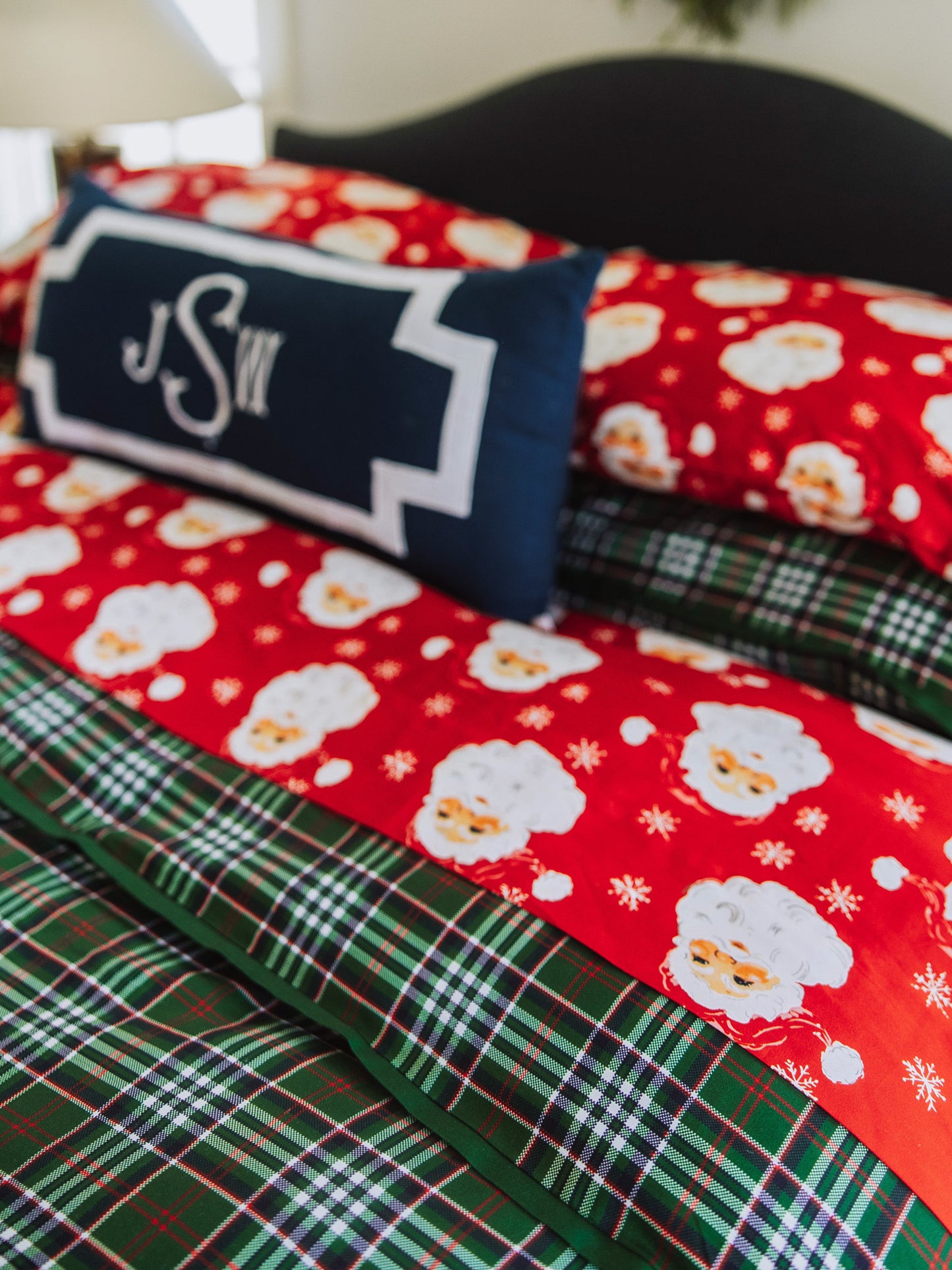 Red Santa sheets on green plaid duvet