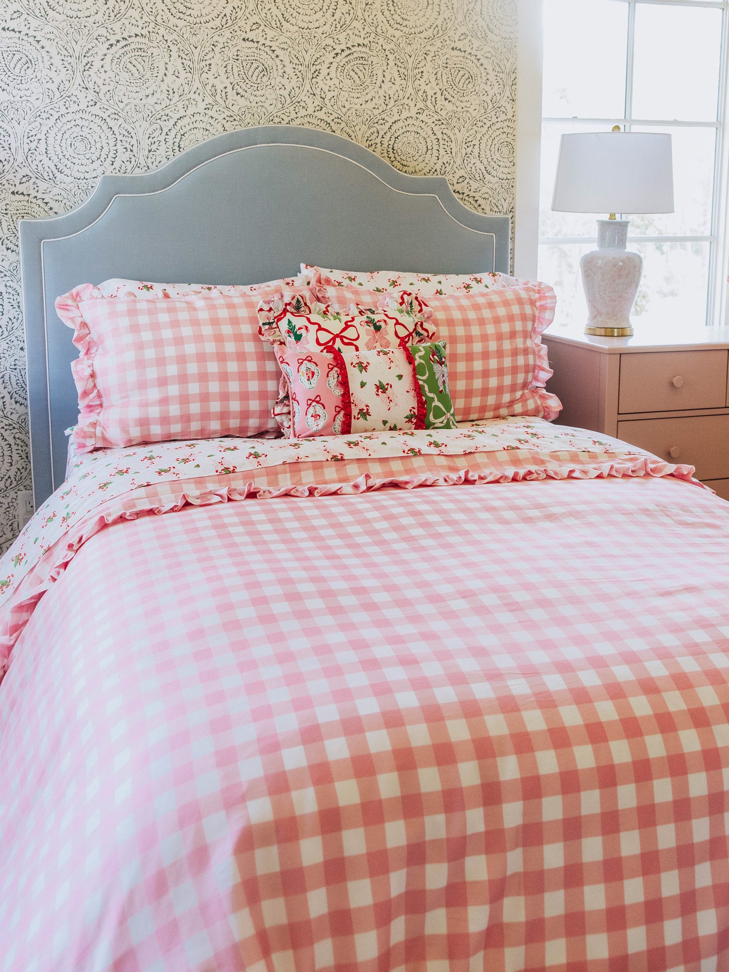 holiday themed bedding with pink gingham print and other matching holiday prints.
