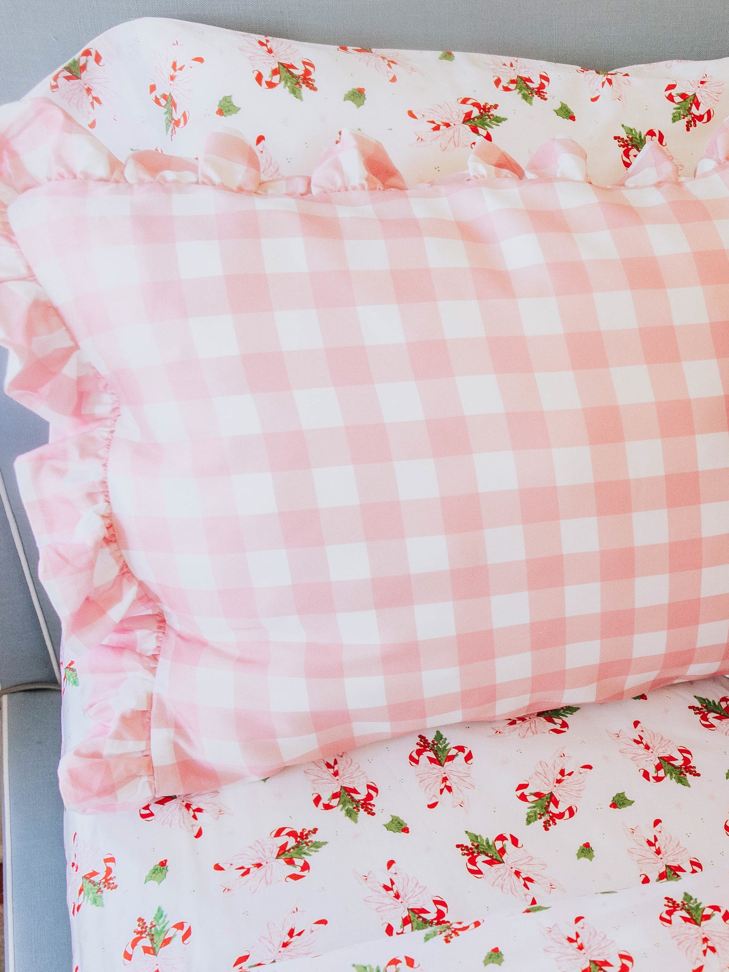 Pink check pillow case with pink candy cane sheets.
