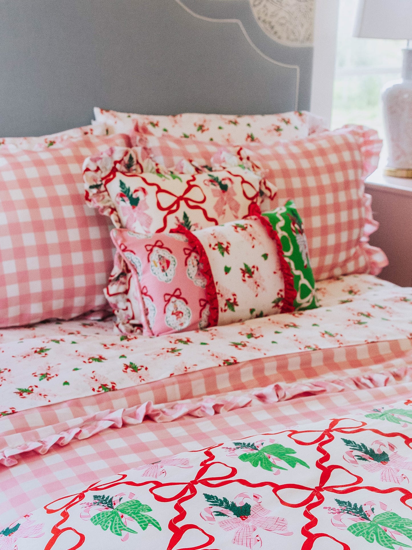 holiday themed bedding with pink gingham print and other matching holiday prints.