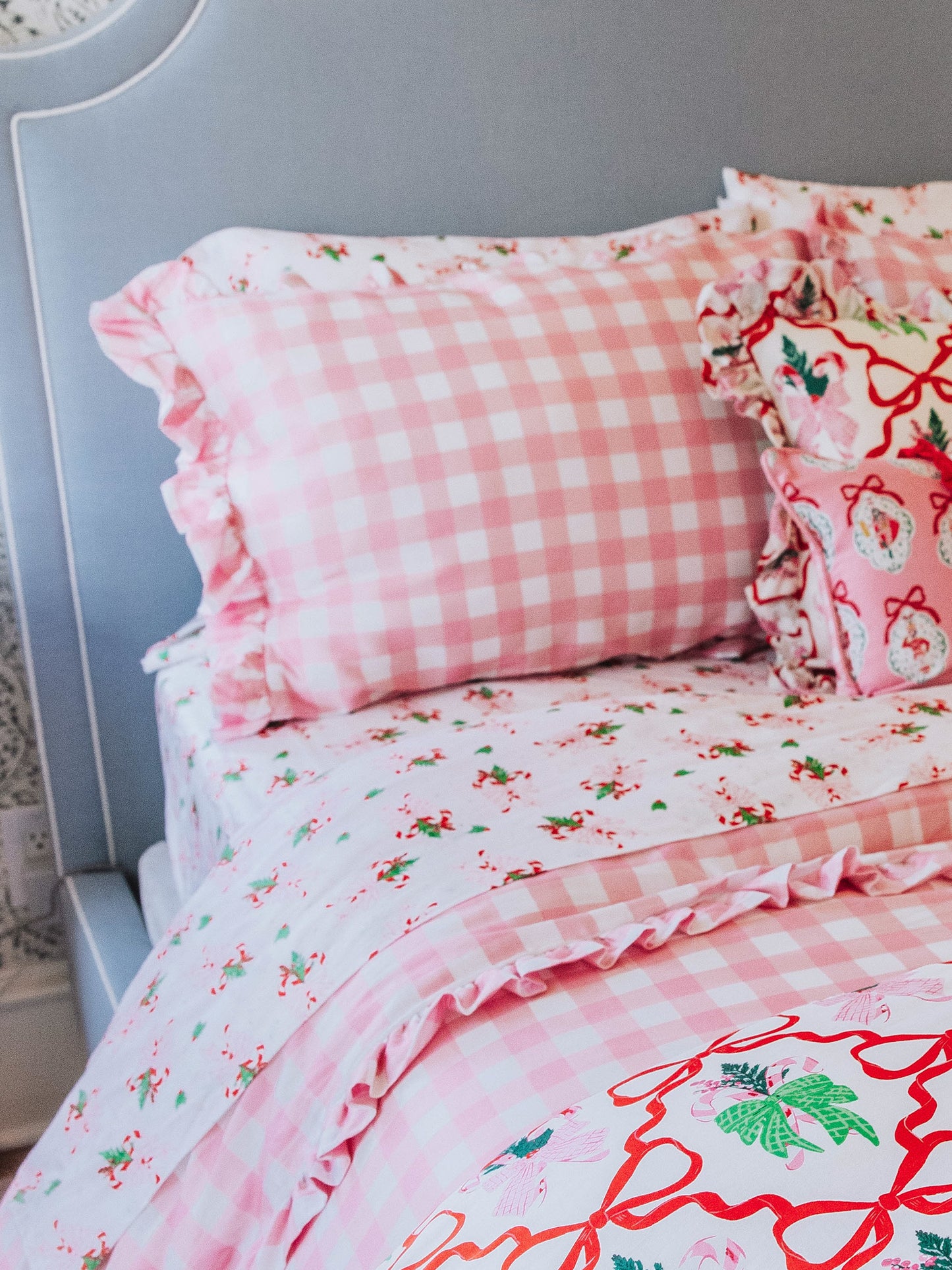 holiday themed bedding with pink gingham print and other matching holiday prints.