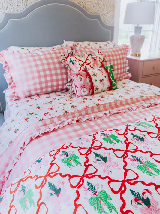 holiday themed bedding with pink gingham print and other matching holiday prints.