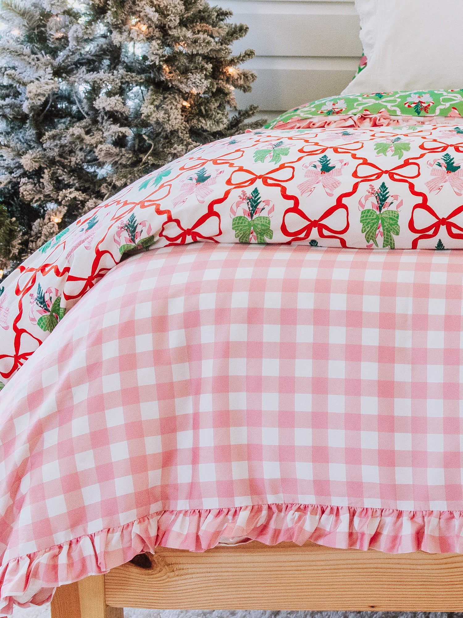holiday themed bedding with pink gingham print and other matching holiday prints