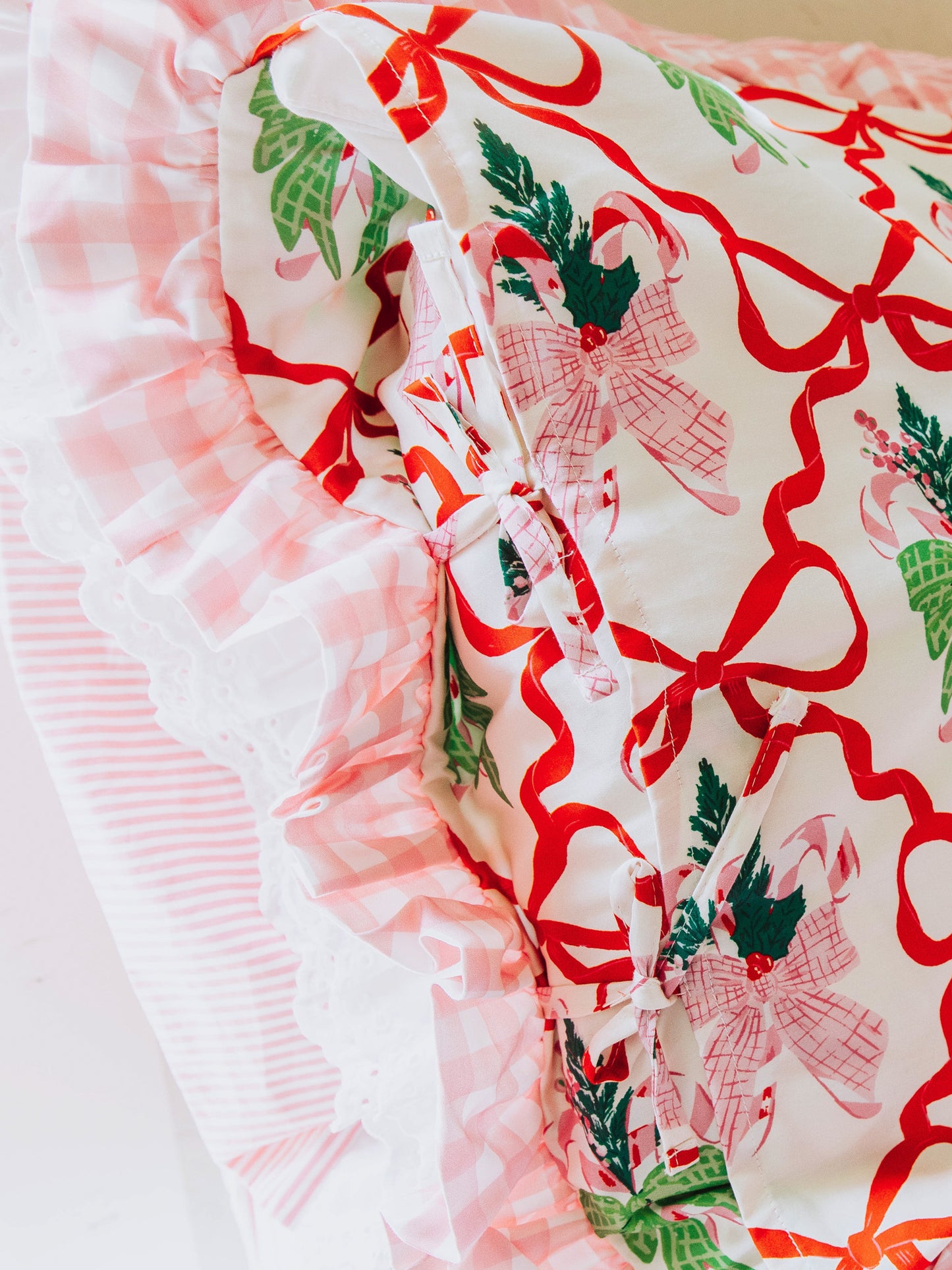 Up close picture of tie closures on Christmas themed pillow case. 