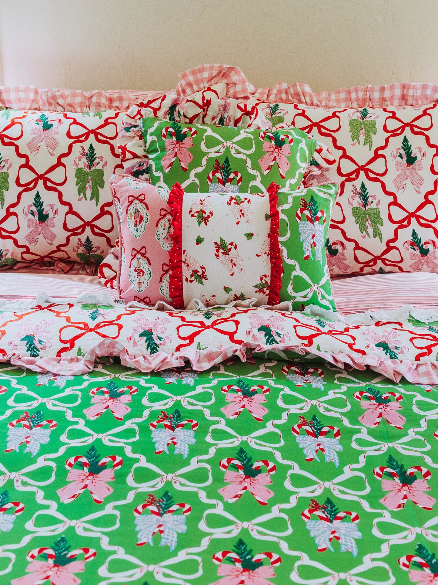 Holiday themed bedding shown with different sized pillows in matching prints. 
