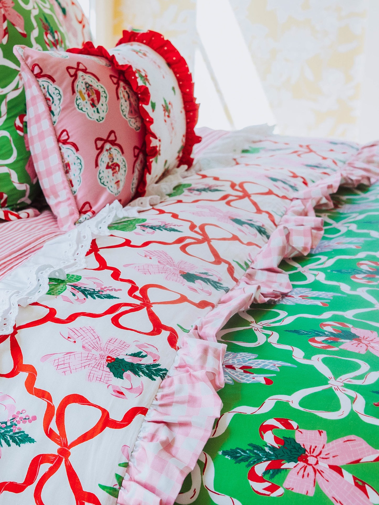 Up close picture of Christmas themed bedding. Bedding is reversable with same print in different color ways.