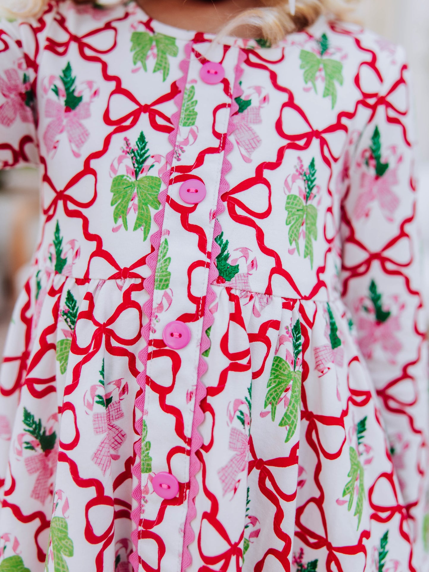 Up close picture of the buttons down front of holiday pattern dress. 