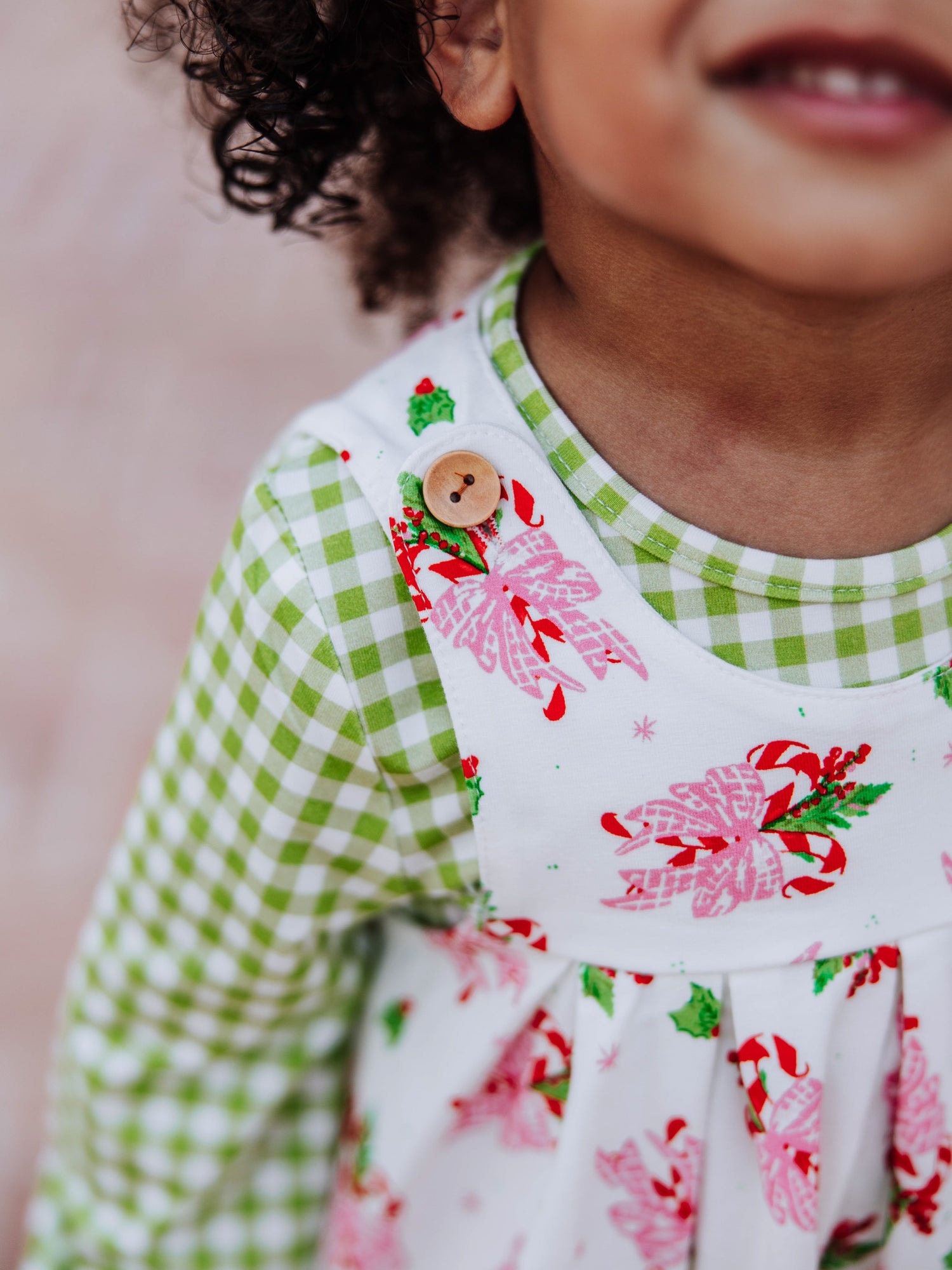 Up close picture of button on shoulder of retro jumper. 