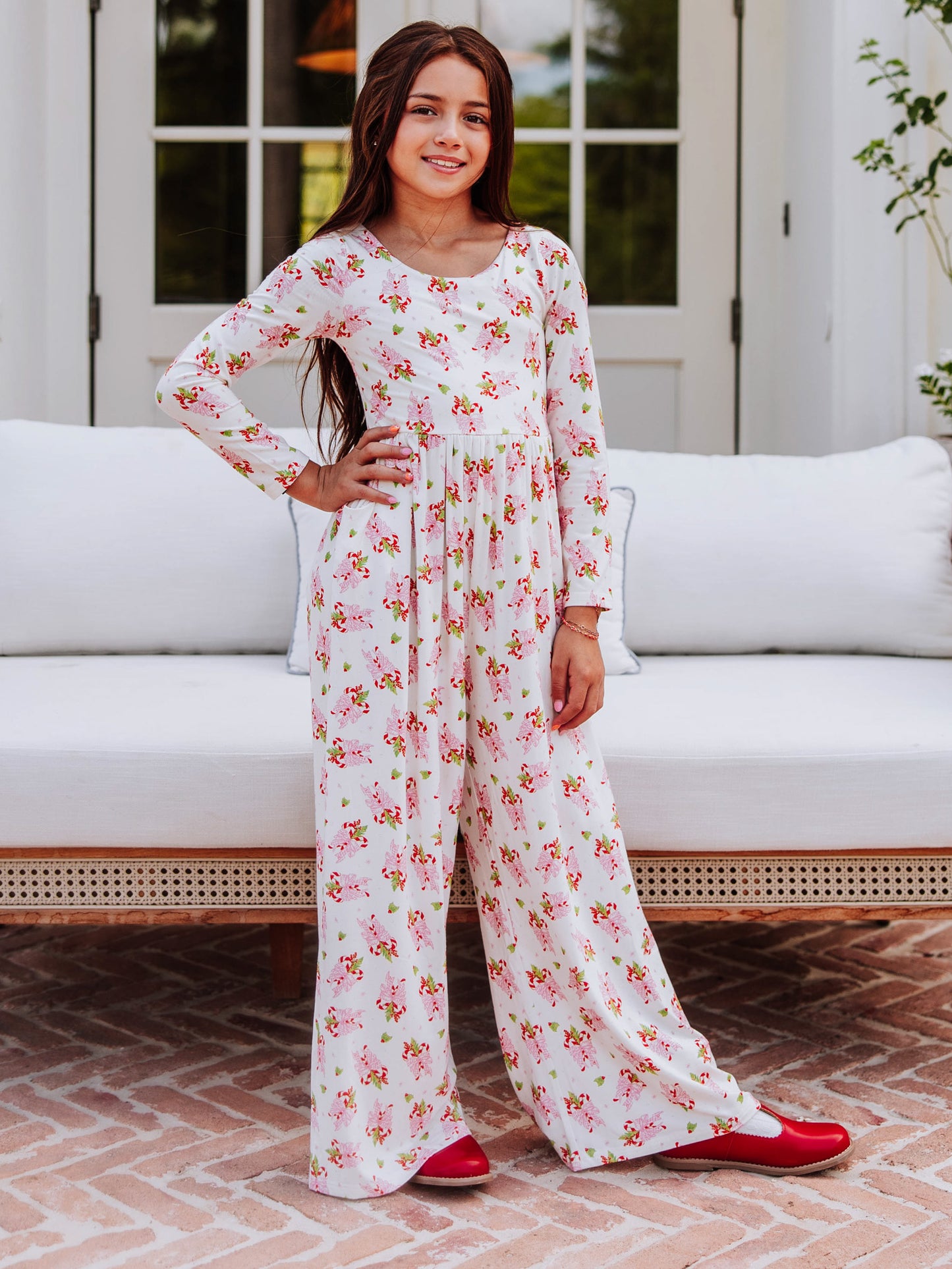 Model wearing a sweet candy cane printed leggy romper. 