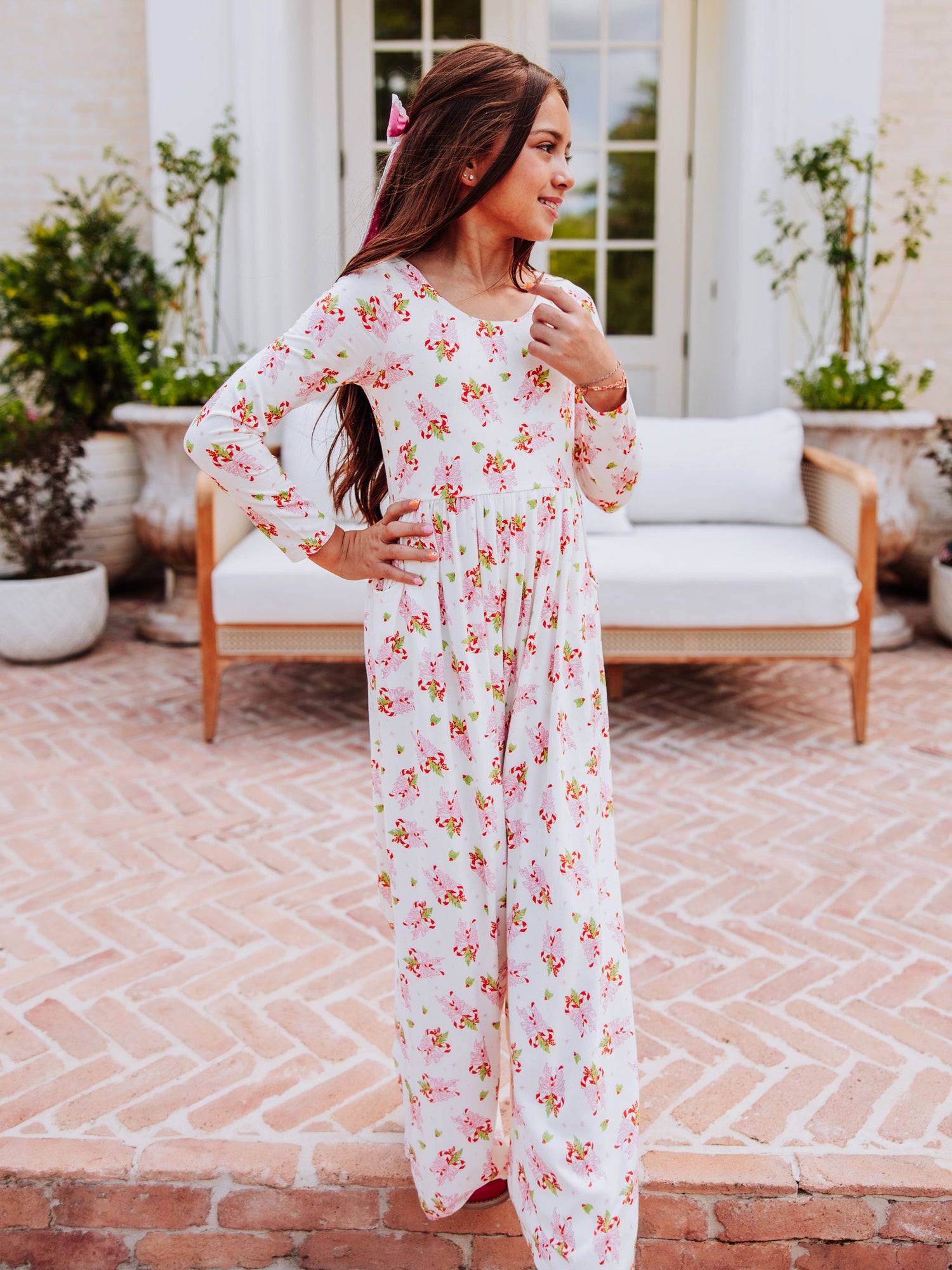 Model wearing a sweet candy cane printed leggy romper. 