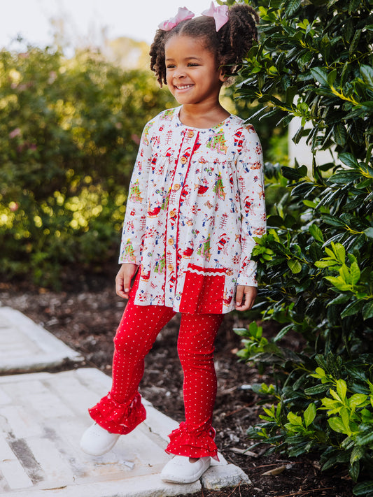 Girl wearing a Holiday themed top with red leggings with white polka dots. This set is an out to play set. 