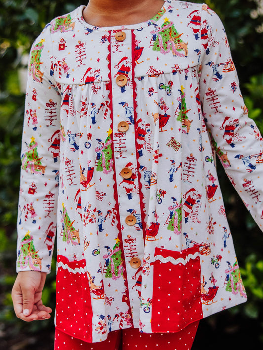 Girl wearing a Holiday themed top with red leggings with white polka dots. This set is an out to play set. 