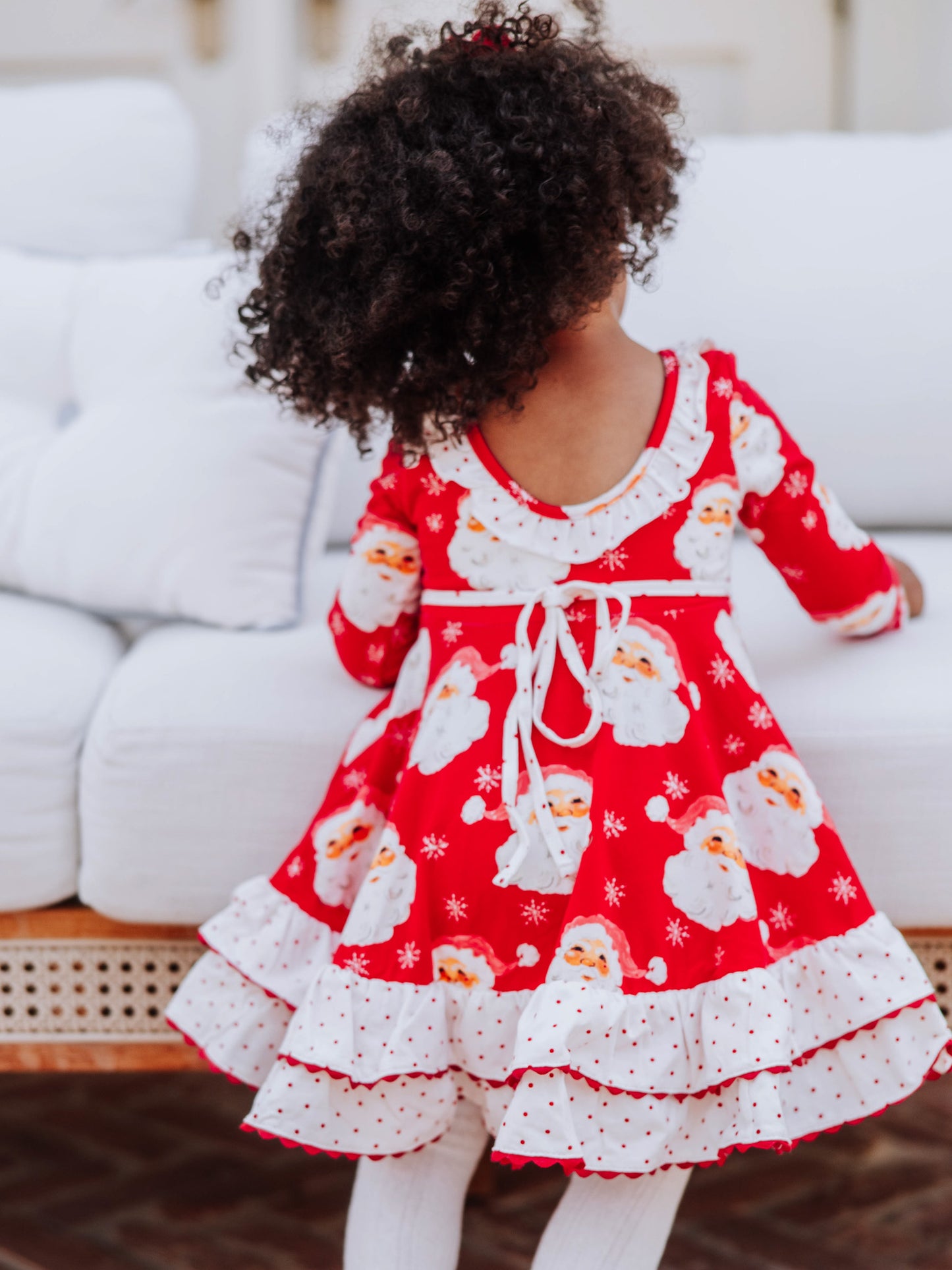 Backside of red jolly santa dress. Pic shows tie and scooped ruffled back. 