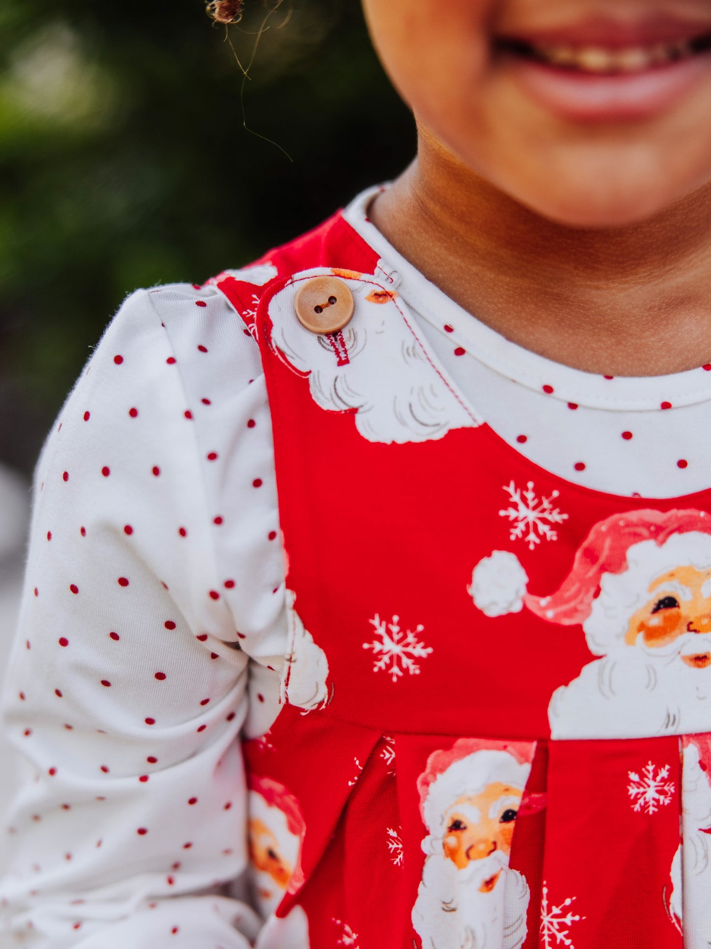 Up close picture of a button on the shoulder of a retro jumper. 