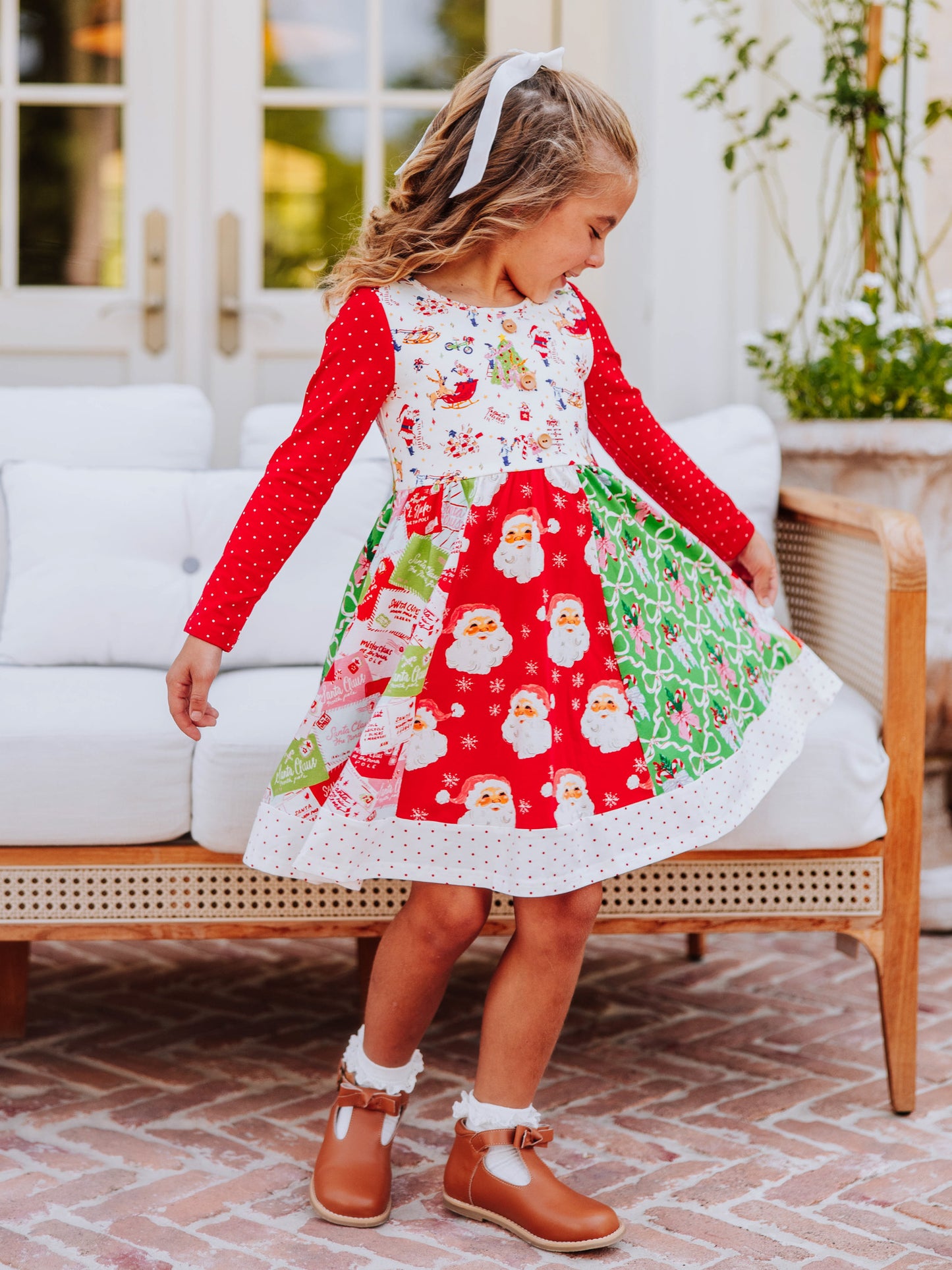 Girl wearing a quirky multi-patterned holiday dress.