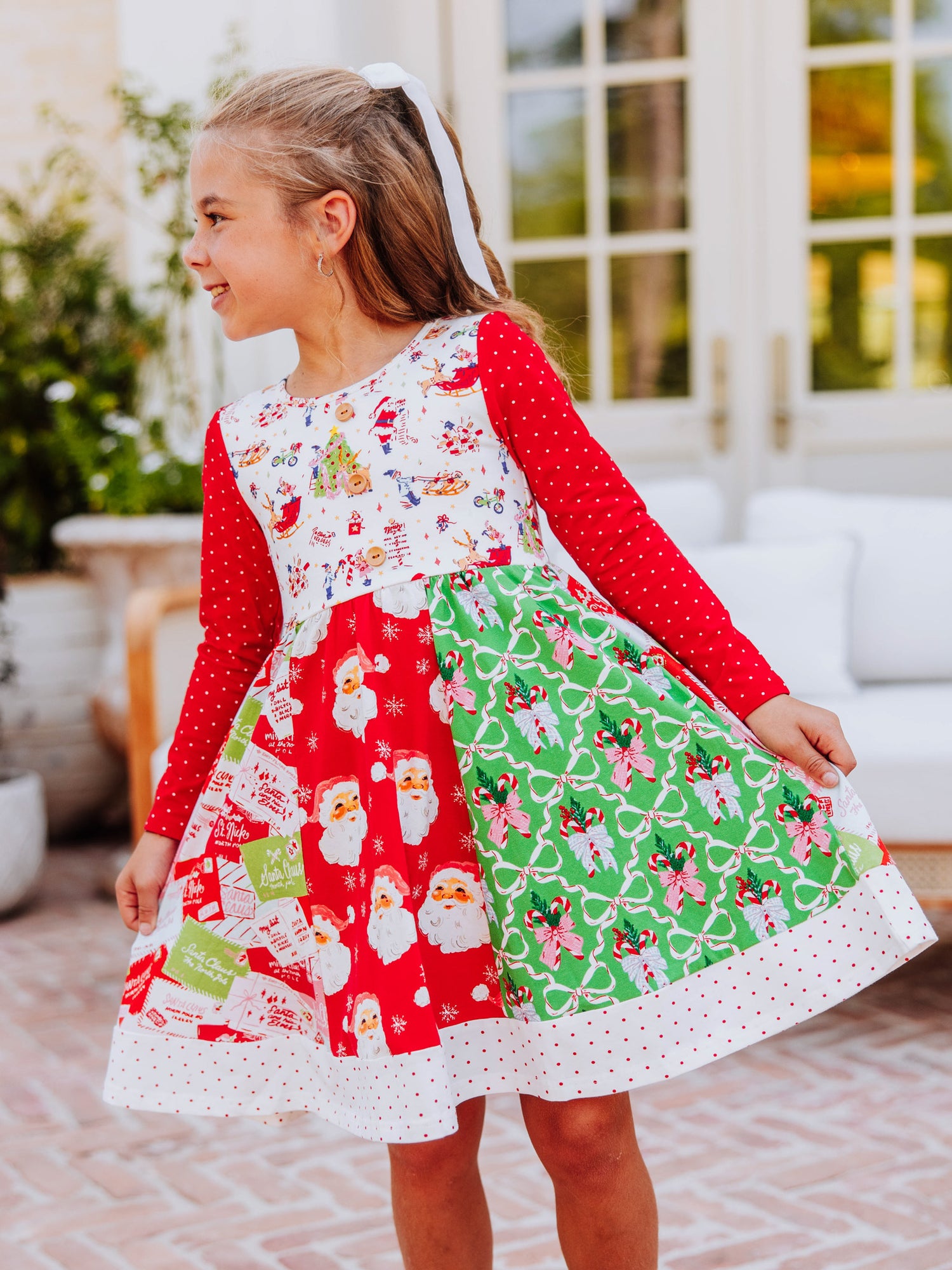Girl wearing a quirky multi-patterned holiday dress.