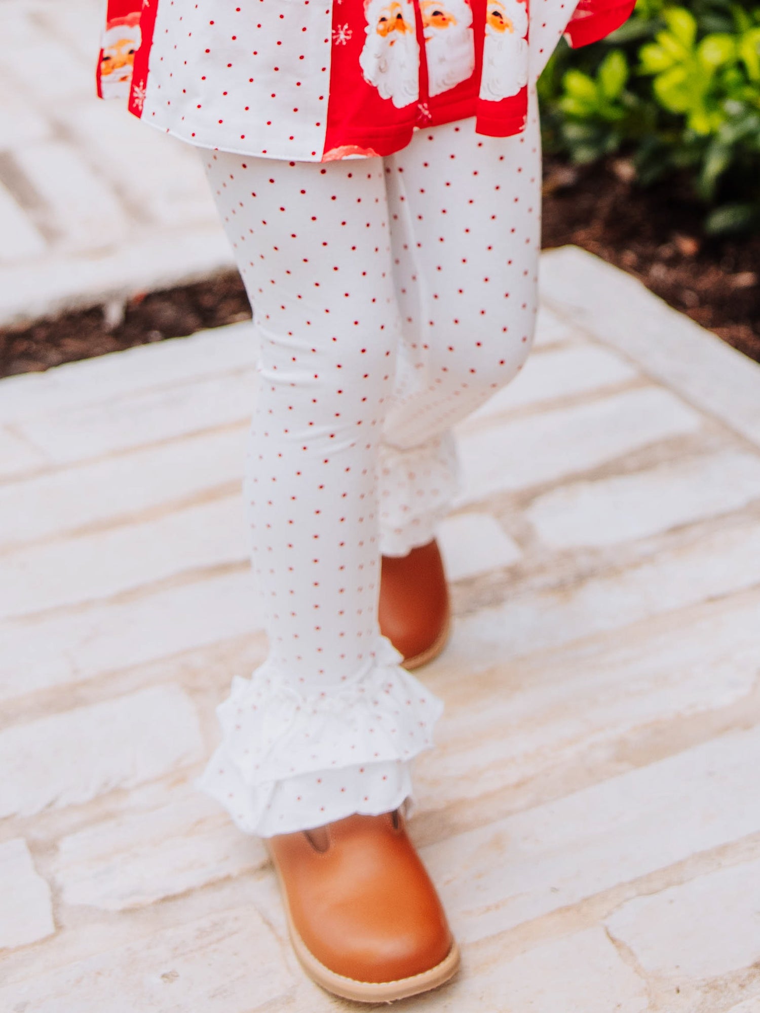 White with red polka dotted leggings with brown buckle shoes. 